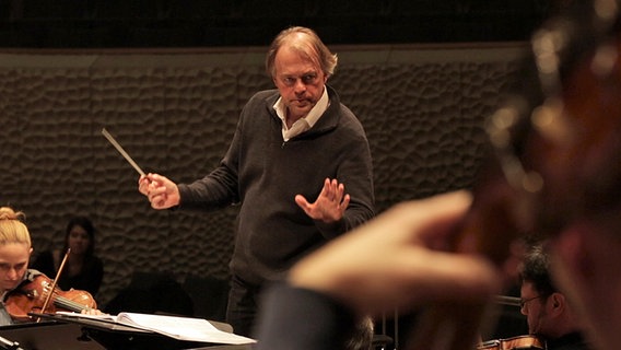 Thomas Hengelbrock dirigiert eine Probe mit dem NDR Elbphilharmonie Orchester (Screenshot) © NDR 