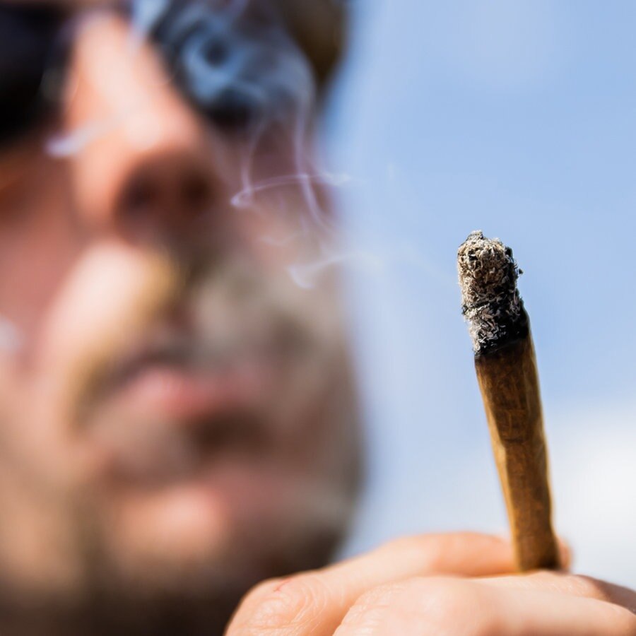 Ein Mann raucht bei einer Demonstrationen einen Joint mit Medizinalcannabis. © Picture Alliance Foto: Christoph Soeder