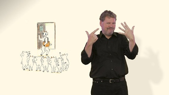 Ein Mann gebärdet, links von ihm eine Zeichnung von einem Wolf und sieben Geißlein.  