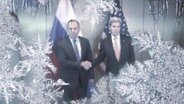 Die Außenminister der USA und Russland auf einem Foto, geben sich die Hand. Über das Foto laufen Eiskristalle und Eiszapfen.  