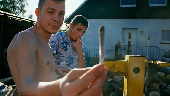 René und Timo rauchen im Garten. © NDR Foto: Christoph Heymann