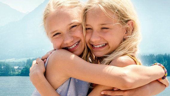 Zwei blonde Mädchen lachen und umarmen sich. Zwei blonde Mädchen lachen und umarmen sich. © SWR/Uschi Reich Filmproduktion GmbH/Hendrik Heiden Foto: Hendrik Heiden