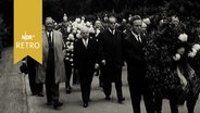 Trauergäste bei Gedenkveranstaltung für Kurt Schumacher an dessen 10. Todestag 1962 auf einem Friedhof.  