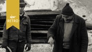 Polier zeigte einem Bauarbeiter auf einer Baustelle etwas auf dem Boden (1963)  