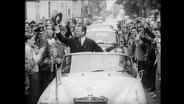 Willy Brandt in einem Cabrio.  