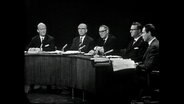 Mehrere Männer sitzen um einen halbrunden Tisch (Archivbild)  