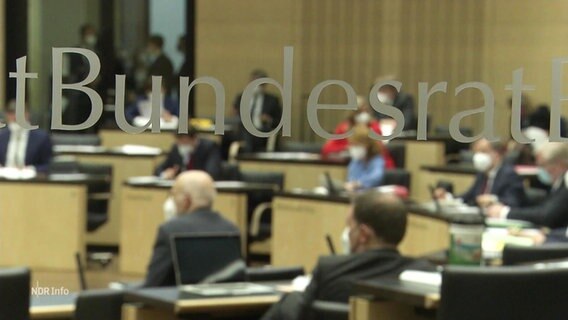 Blick in den Bundesrat durch eine Glasscheibe; im Vordergrund der Schriftzug "Bundesrat" auf dem Glas.  