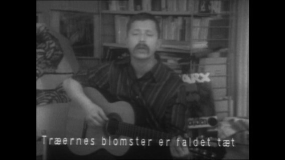 Wolf Biermann mit einer Gitarre im dänischen Fernsehen  
