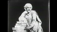 Büste von William Shakespeare, auf einen Bücherstapel gestützt (1964 in einer englischen Ausstellung)  