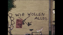 Ein Graffiti "Wir wollen Alles"  