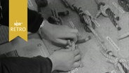 Hände beim Üben verschiedener Knoten in einer Mitmach-Ausstellung 1964  