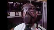 Ein Mann trägt eine Giftgasmaske  