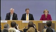 Guido Westerwelle zwischen Angela Merkel und Horst Seehofer  