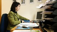 Eine Frau an einem Schreibtisch  
