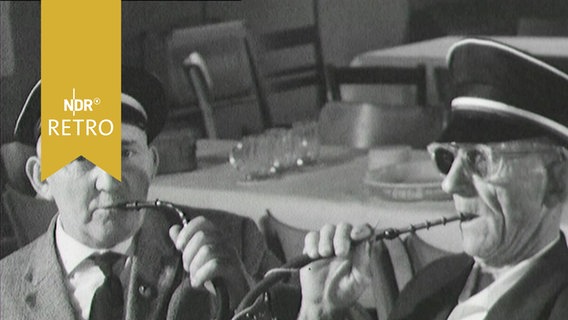 Zwei Raucher bei einem Wettrauchen mit langen gebogenen Pfeifen (1963)  