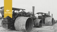 Große Walzen stehen auf einem Feld im Emsland 1964  