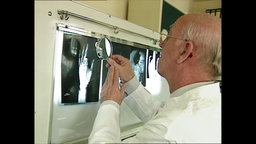 Ein Arzt vor einem Röntgenbild  