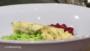 Fiskbullar with soft peas and cranberry sauce.  