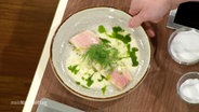 A plate of trout fillets from the oven with pear sauce and dill oil.  