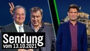 Markus Söder macht hinter Armin Laschet Hasenohren, daneben Christian Ehring.  