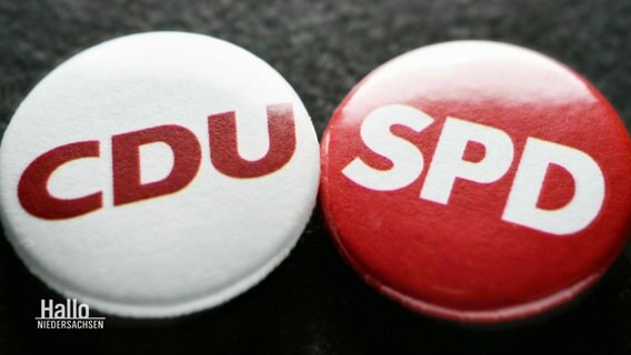 Zwei Buttons mit den Aufdrucken CDU und SPD.  