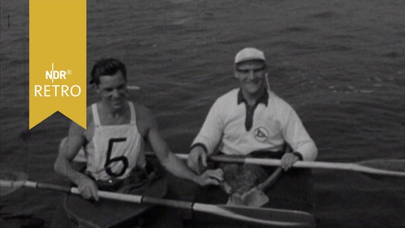 Zwei Kanuten in ihren Booten nach der Regatta zur Insel Norderney (1963)  