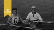 Zwei Kanuten in ihren Booten nach der Regatta zur Insel Norderney (1963)  