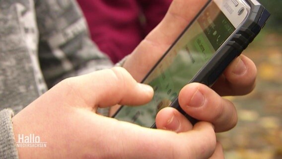 Ein Junge hält ein Smartphone in den Händen. © Screenshot 