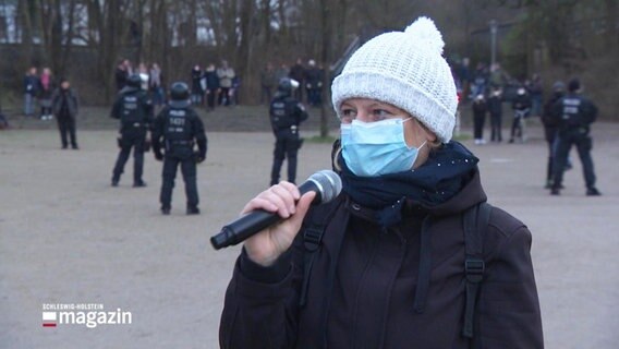 Eine Demonstrantin spricht in ein Mikrofon. © Screenshot 