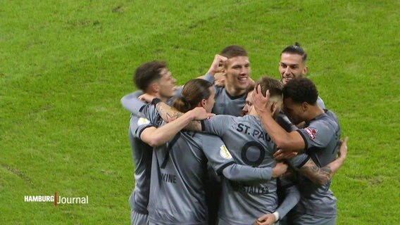 Fußballspieler des FC St. Pauli feiern am Spielfeldrand den Sieg gegen Borussia Dortmund. © Screenshot 