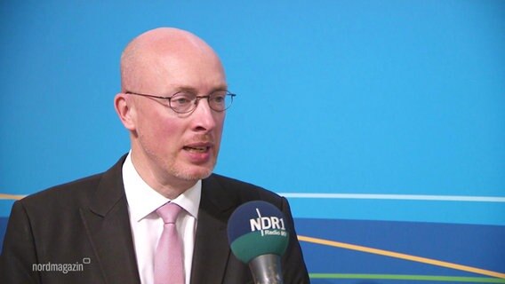Der Innenminister von Mecklenburg Vorpommern Christian Pegel spricht in ein Mikrofon. © Screenshot 