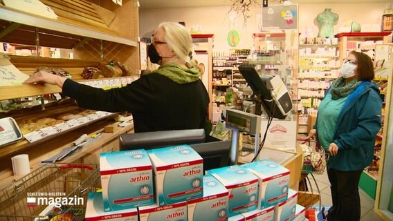 In einem Laden fast ohne Produktverpackungen kauft lässt sich eine Kundin von einer Verkäuferin ein Brot geben. © Screenshot 