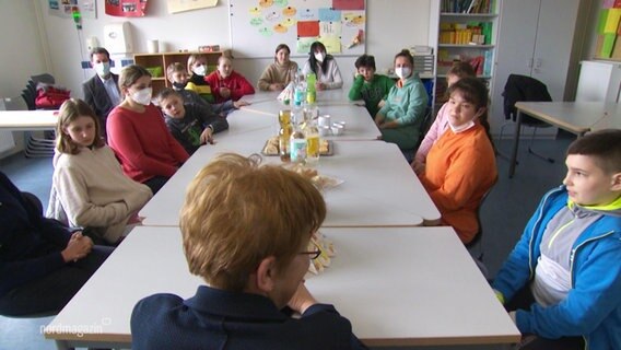 Kinder aus der Ukraine sitzen gemeinsam an einem Tisch in einer Schule in Bergen. © Screenshot 