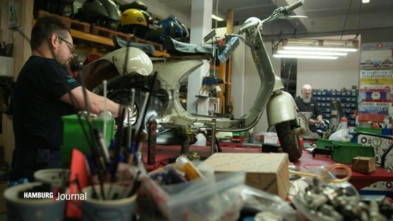 Eine Vespa steht aufgebockt in einer Werkstatt. © Screenshot 