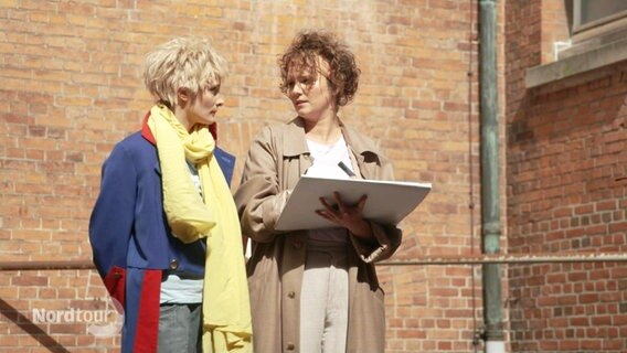 Zwei Schauspielerinnen auf der Bühne. © Screenshot 