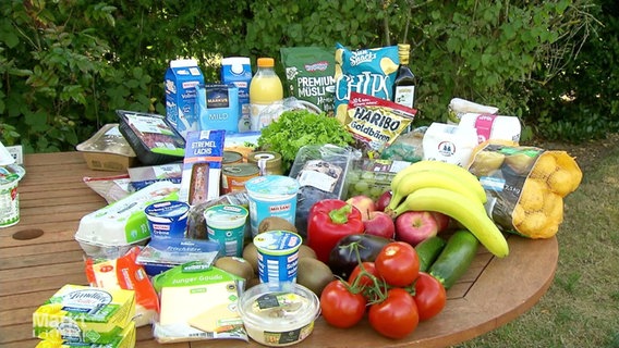 Eine große Auswahl an Lebensmitteln liegt auf einem Holztisch © Screenshot 