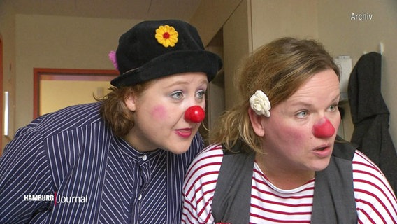 Zwei Frauen mit Clownsnasen schauen erstaunt © Screenshot 