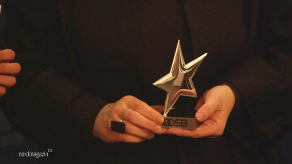 Das Bild zeigt die Trophäe bei der Verleihung. © Screenshot 
