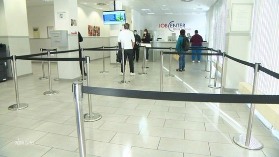 Menschen stehen im Wartebereich eines Job-Centers. © Screenshot 