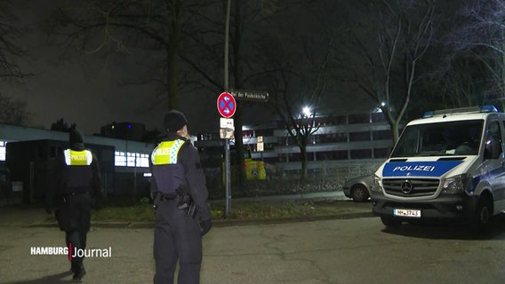 Polizeibeamte stehen auf einer Straße bei Nacht © Screenshot 