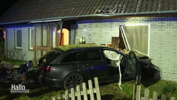 Ein Auto steckt nach einem Unfall in der Wand eines Wohnhauses © Screenshot 