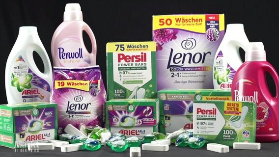 Waschmittel unterschiedener Marken stehen auf einem Tisch © Screenshot 