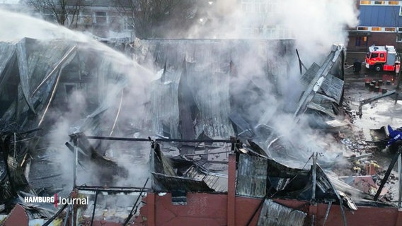 Blick aus der Vogelperspektive auf eine ausgebrannte Turnhalle deren Dach eingefallen ist. © Screenshot 