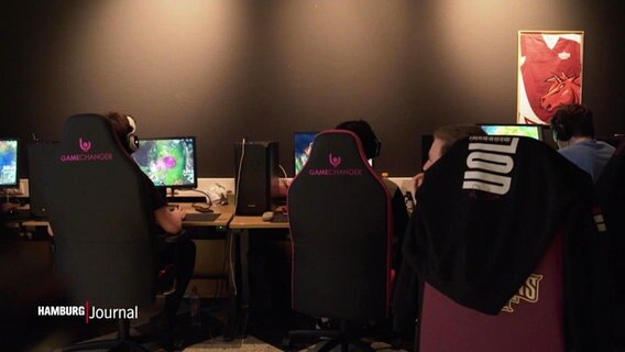 Ein Raum mit Personen auf Gaming Stühlen, die am Computer sitzen © Screenshot 