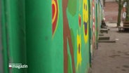 Die grüne und bemalte Wand einer Schule © Screenshot 