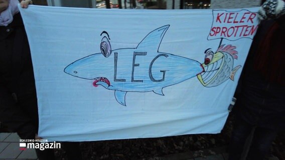 Ein Banner mit einem Hai und einem kleineren Fisch, der ihm in den Schwanz beißt © Screenshot 