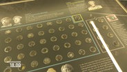 Polierte römische Münzen liegen in einer Vitrine © Screenshot 