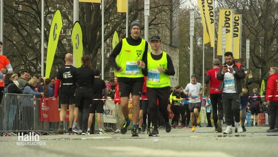 Zwei Marathonläufer mit gelben Westen © Screenshot 