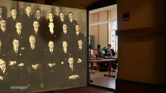 Das Klassenfoto des Abiturjahrgangs. Rechts kann in einen Klassenraum geschaut werden. Dort sitzen zwei Männer. © Screenshot 