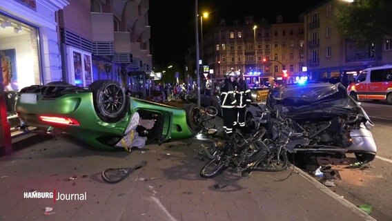 Ein grüner Sportwagen liegt auf dem Dach, offensichtlich hat es einen Unfall gegeben. © Screenshot 